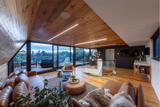 Verdant Avenue, Toorak — Timber-lined living room with city views