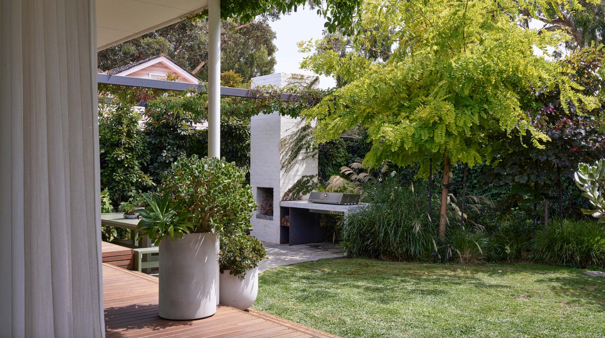 Brighton East Garden House — Deck seating and planted garden