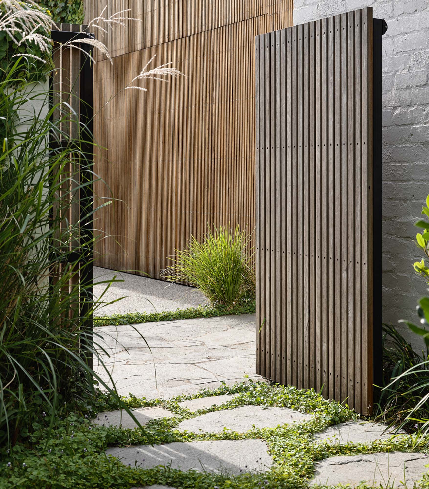 Brighton East Garden House — Outdoor shower beside a garden path