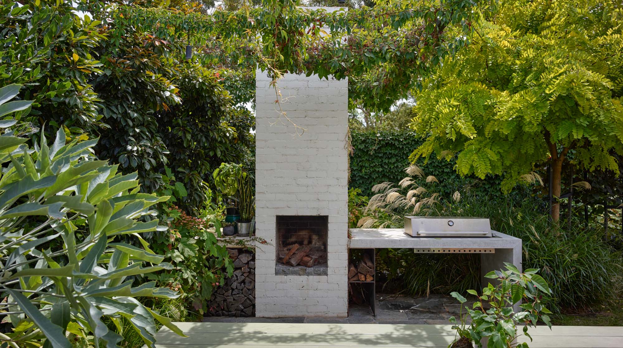 Brighton East Garden House — Outdoor fireplace and garden seating